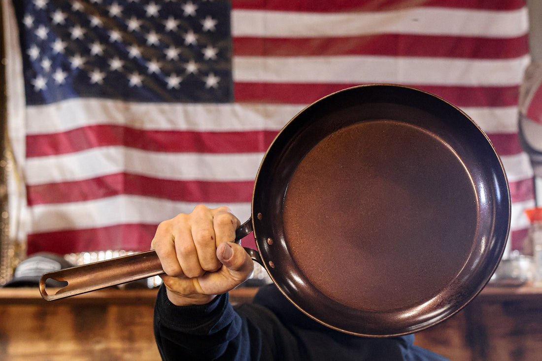 Texas Pan Company carbon steel skillet held in front of an American flag