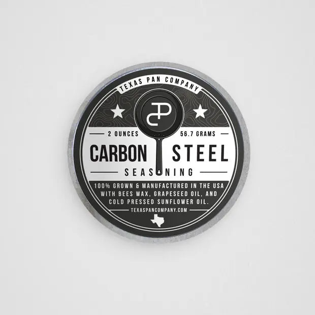 Carbon Steel Seasoning tin photographed from above, showing the full label
