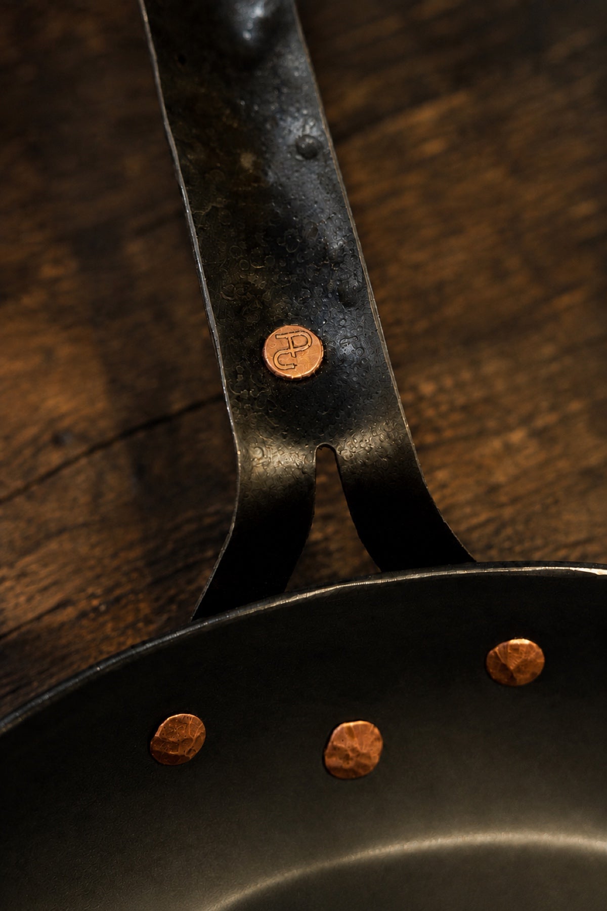 Texas Pan Company logo rivet above three copper rivets joining the handle to the skillet