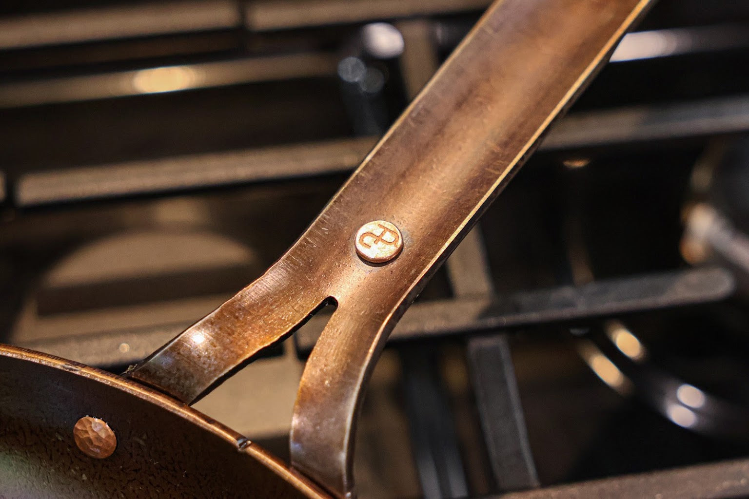 Close-up of the steel handle and the copper rivet engraved with the Texas Pan Company logo